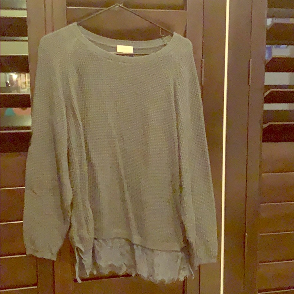 Grey sweater with lace detail.